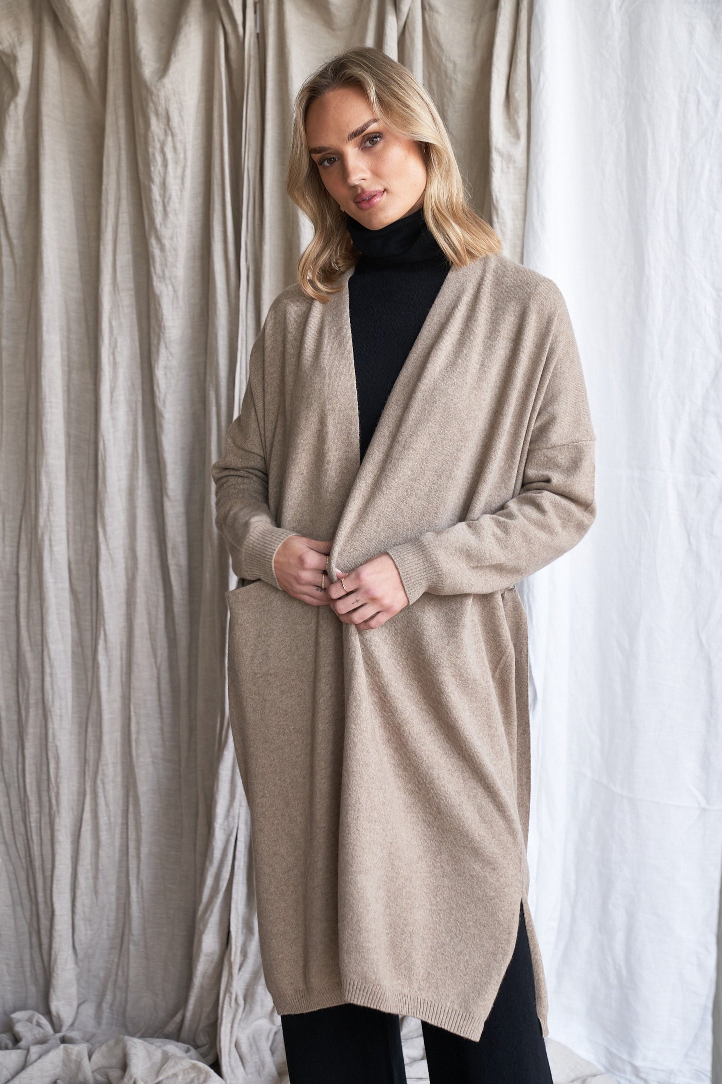 Long Mushroom Cashmere Cardigan with Belt & Pockets – Women’s Coatigan | 100% Pure Cashmere
Wrap yourself in luxury with our long cashmere cardigan in mushroom, designed with a soft belted waist and practical front pockets. Made from 100% pure, ethically sourced cashmere, this elegant coatigan-style knit offers a relaxed, robe-like silhouette perfect for layering during cooler months.
The neutral taupe-grey tone makes it endlessly versatile, while the detachable belt allows for multiple styling options. W