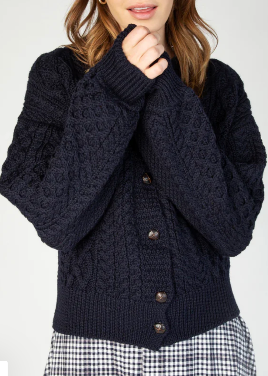This cardigan showcases an artful blend of traditional knit techniques, featuring classic Aran-inspired cables, honeycomb textures, and basketweave patterns throughout. Each stitch is thoughtfully placed, creating a visually rich and tactile fabric that feels as cozy as it looks. The chunky knit design offers a warm, breathable layer perfect for cooler seasons, while the voluminous sleeves and ribbed trims add a modern finish to this timeless piece. Whether you're dressing it up or down, this knit is a stan