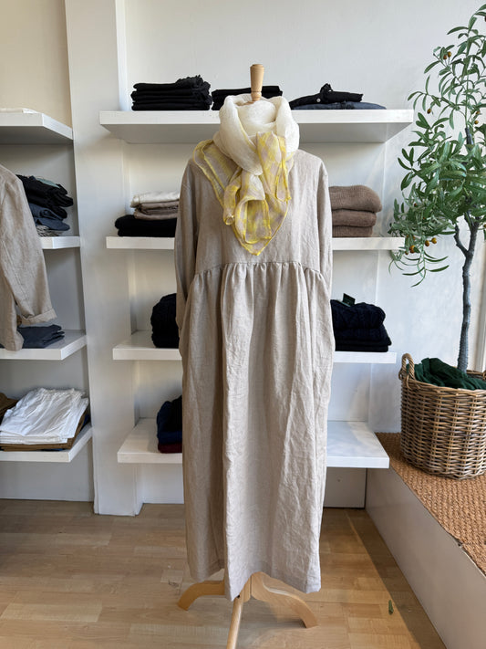 Refined and timeless, the Willow Linen Gathered Dress in navy brings effortless sophistication to everyday dressing. Made from 100% pure linen, this piece features a relaxed, free-flowing fit with a softly gathered waist that creates gentle structure and movement. The rich navy hue adds depth and versatility, making it a year-round staple that transitions seamlessly from day to evening. Designed with a round neckline and full-length sleeves, it layers beautifully with scarves, cardigans, or jackets. Comfort