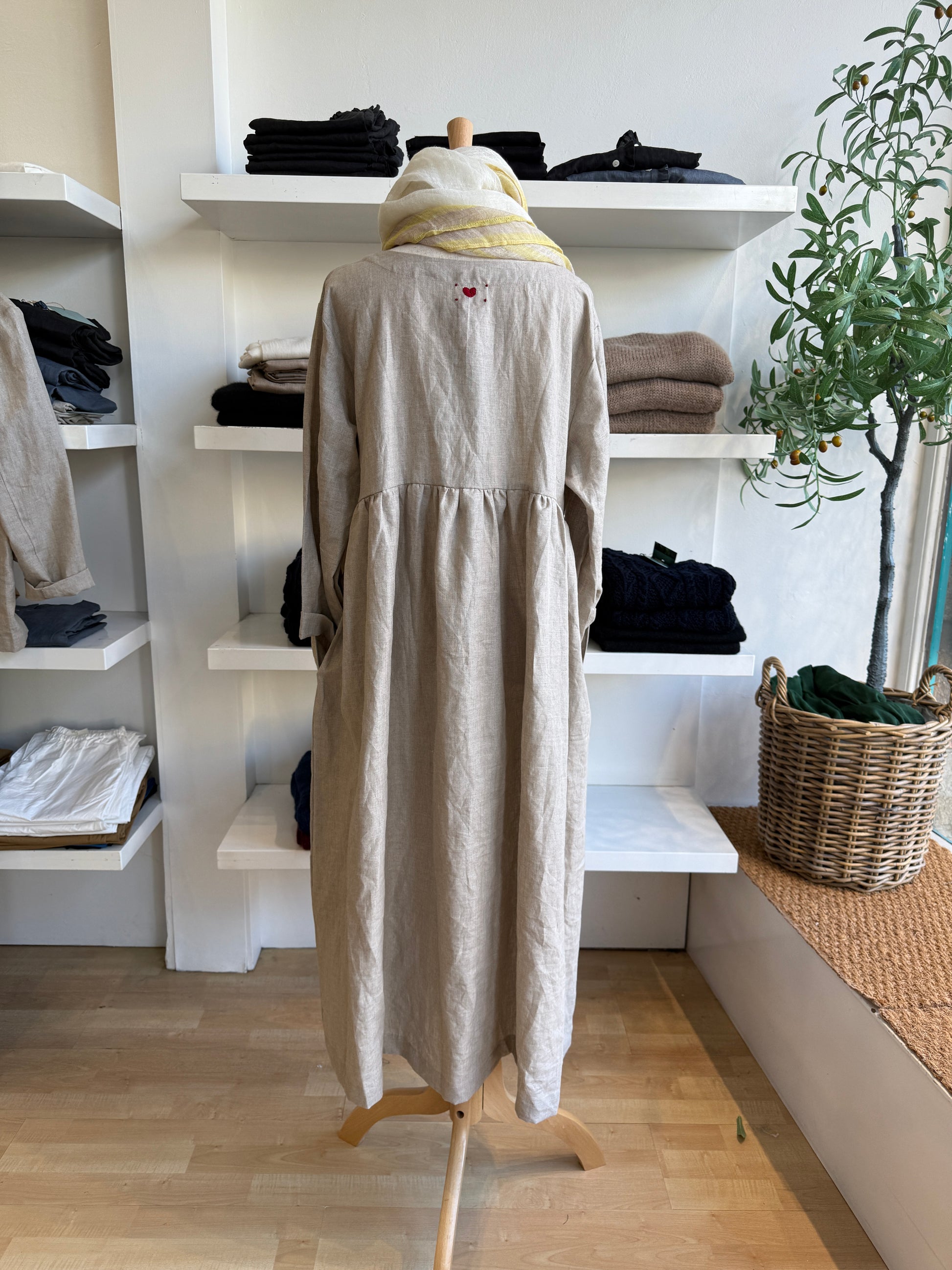 Refined and timeless, the Willow Linen Gathered Dress in navy brings effortless sophistication to everyday dressing. Made from 100% pure linen, this piece features a relaxed, free-flowing fit with a softly gathered waist that creates gentle structure and movement. The rich navy hue adds depth and versatility, making it a year-round staple that transitions seamlessly from day to evening. Designed with a round neckline and full-length sleeves, it layers beautifully with scarves, cardigans, or jackets. Comfort