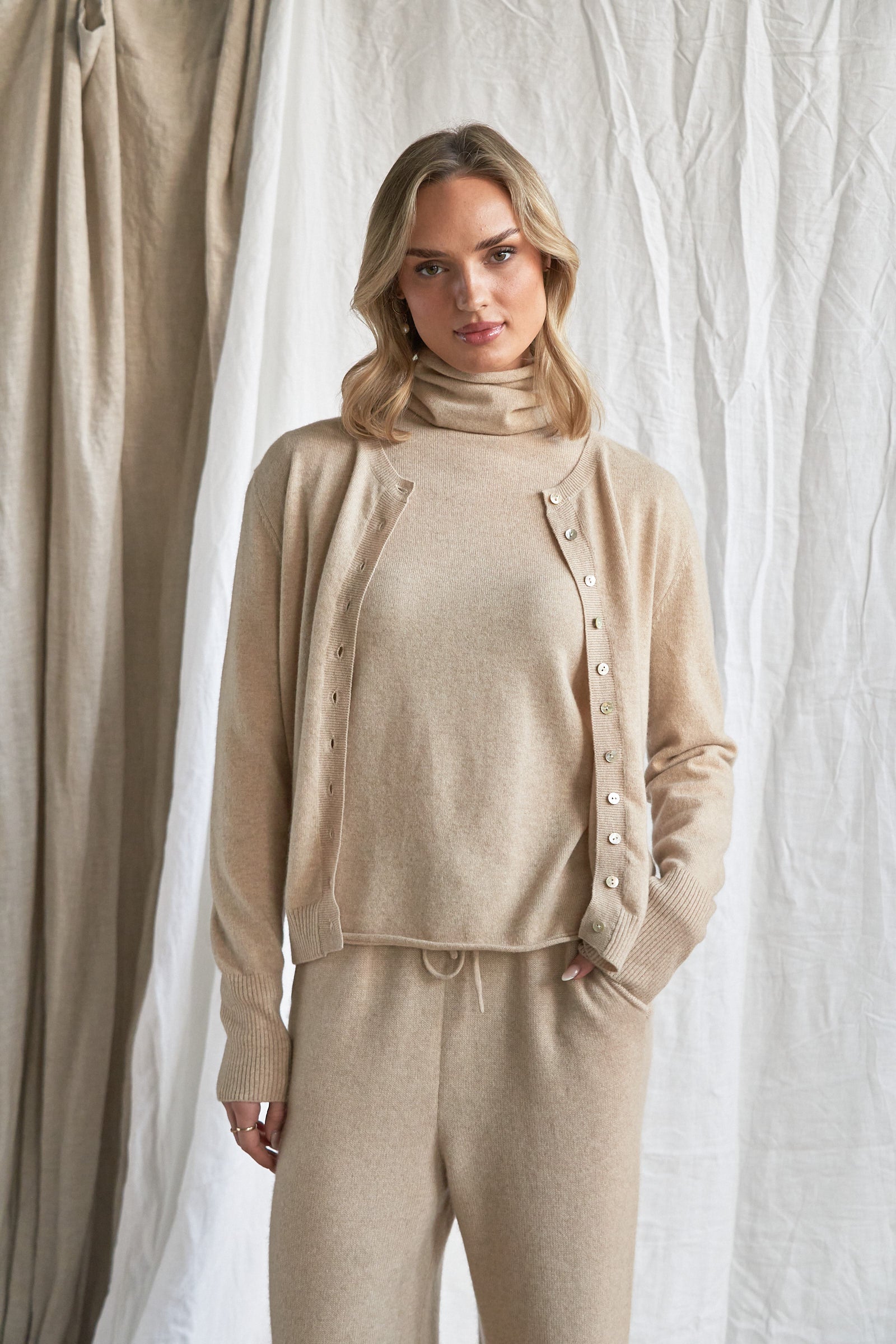 Oatmeal Cashmere Cardigan – Women’s Pure Cashmere Knit with Mother-of-Pearl Buttons

Wrap yourself in understated luxury with our women’s oatmeal cashmere cardigan, crafted from 100% premium-grade cashmere. Designed with a flattering relaxed fit and finished with mother-of-pearl buttons, this soft neutral knit is the perfect balance of comfort and elegance.

Ideal for layering through every season, this beige cashmere cardigan is lightweight yet warm, offering breathability, softness, and timeless style. 