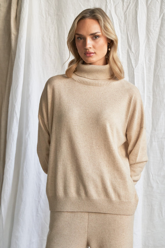 Indulge in the soft luxury of our oversized oatmeal cashmere sweater, designed with a high neckline and relaxed fit for all-day comfort. Made from 100% pure, ethically sourced cashmere, this roomy women’s knit features wide sleeves, drop shoulders, and a soft neutral hue that complements every wardrobe.

Perfect for layering or lounging, this high neck oversized sweater is a modern essential for effortless cold-weather dressing. Soft, breathable, and naturally insulating — it’s winter comfort with elevated 