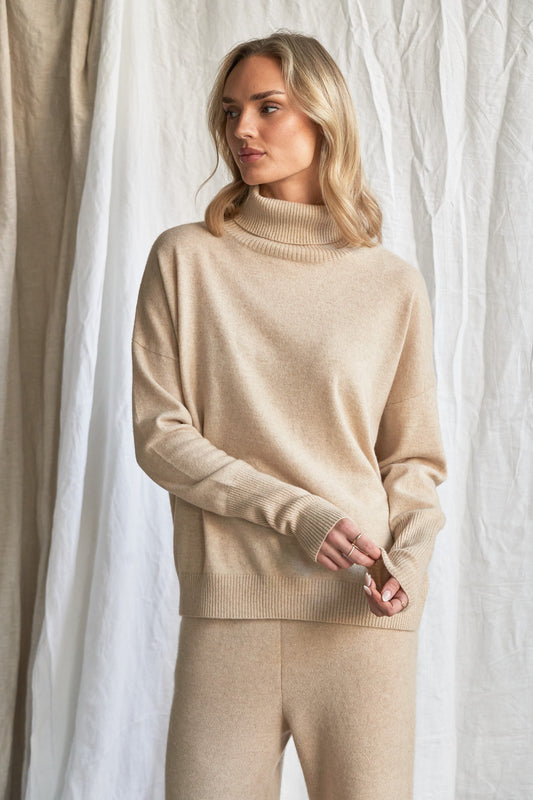 Indulge in the soft luxury of our oversized oatmeal cashmere sweater, designed with a high neckline and relaxed fit for all-day comfort. Made from 100% pure, ethically sourced cashmere, this roomy women’s knit features wide sleeves, drop shoulders, and a soft neutral hue that complements every wardrobe.

Perfect for layering or lounging, this high neck oversized sweater is a modern essential for effortless cold-weather dressing. Soft, breathable, and naturally insulating — it’s winter comfort with elevated 