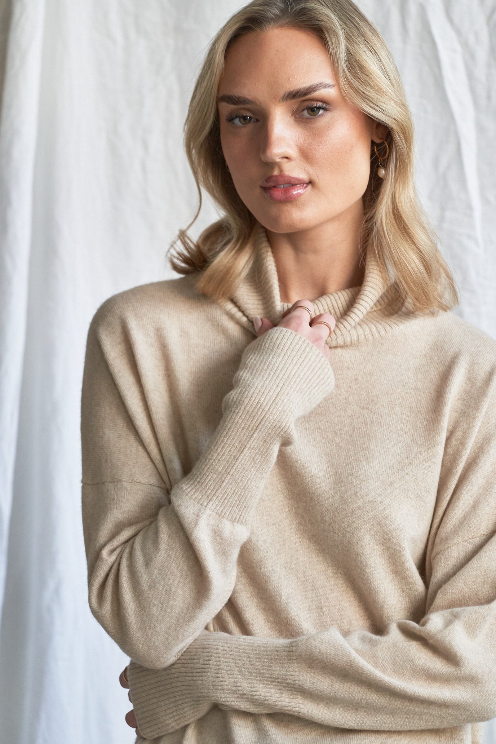 Indulge in the soft luxury of our oversized oatmeal cashmere sweater, designed with a high neckline and relaxed fit for all-day comfort. Made from 100% pure, ethically sourced cashmere, this roomy women’s knit features wide sleeves, drop shoulders, and a soft neutral hue that complements every wardrobe.

Perfect for layering or lounging, this high neck oversized sweater is a modern essential for effortless cold-weather dressing. Soft, breathable, and naturally insulating — it’s winter comfort with elevated 