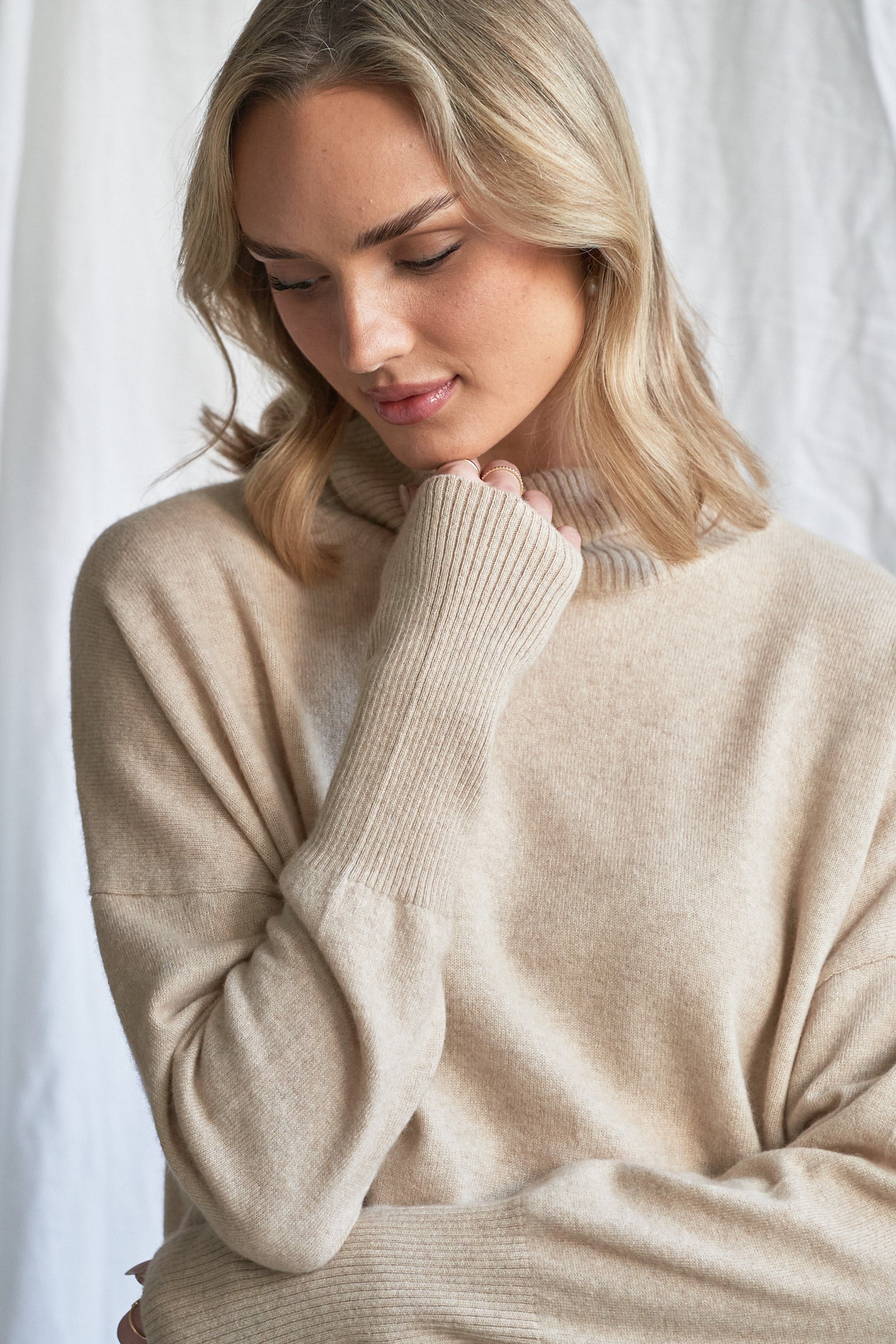 Indulge in the soft luxury of our oversized oatmeal cashmere sweater, designed with a high neckline and relaxed fit for all-day comfort. Made from 100% pure, ethically sourced cashmere, this roomy women’s knit features wide sleeves, drop shoulders, and a soft neutral hue that complements every wardrobe.

Perfect for layering or lounging, this high neck oversized sweater is a modern essential for effortless cold-weather dressing. Soft, breathable, and naturally insulating — it’s winter comfort with elevated 