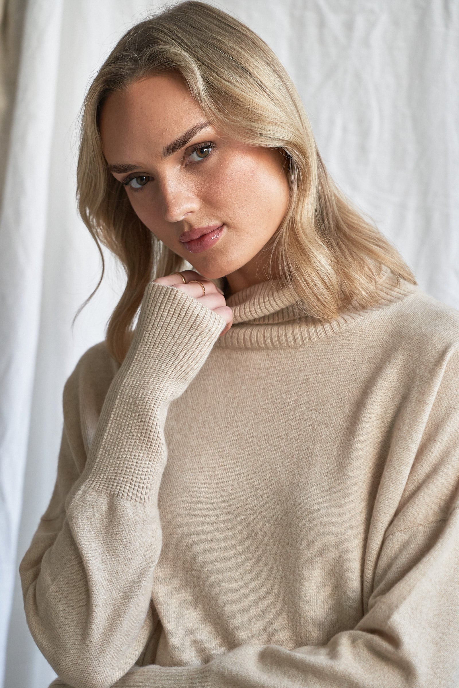 Indulge in the soft luxury of our oversized oatmeal cashmere sweater, designed with a high neckline and relaxed fit for all-day comfort. Made from 100% pure, ethically sourced cashmere, this roomy women’s knit features wide sleeves, drop shoulders, and a soft neutral hue that complements every wardrobe.

Perfect for layering or lounging, this high neck oversized sweater is a modern essential for effortless cold-weather dressing. Soft, breathable, and naturally insulating — it’s winter comfort with elevated 