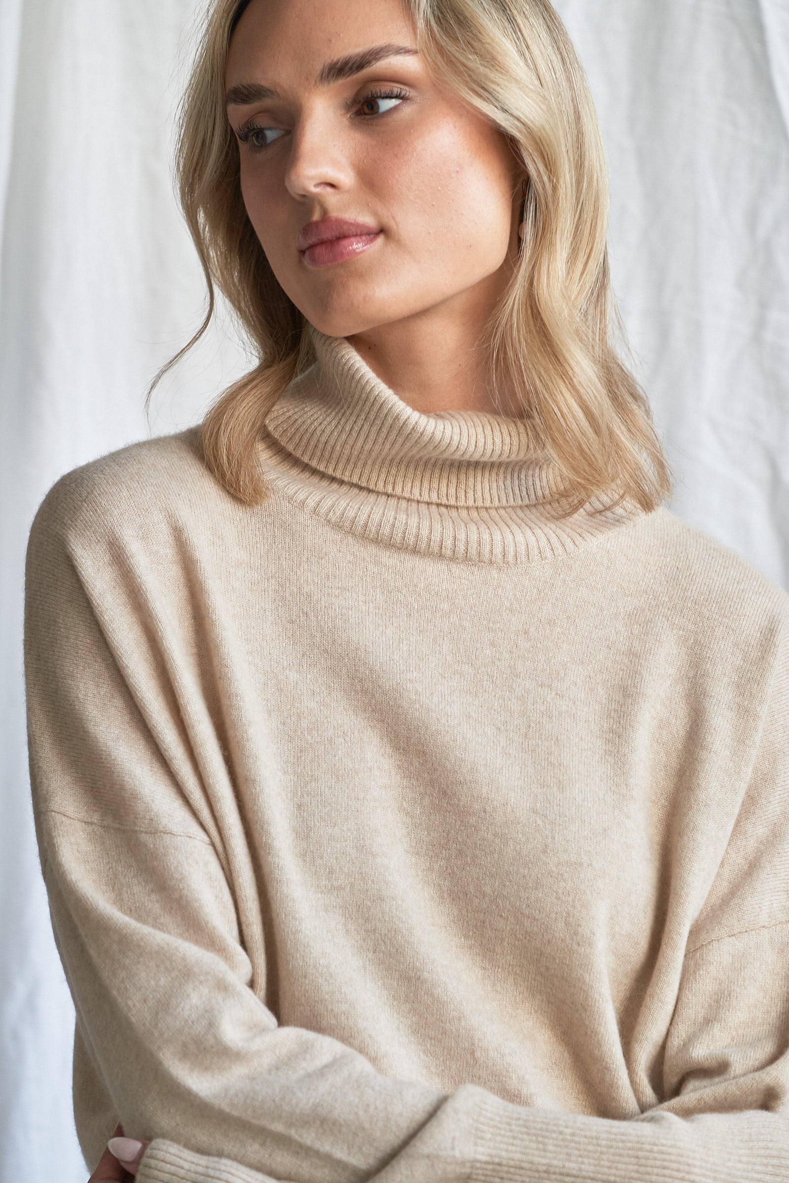 Indulge in the soft luxury of our oversized oatmeal cashmere sweater, designed with a high neckline and relaxed fit for all-day comfort. Made from 100% pure, ethically sourced cashmere, this roomy women’s knit features wide sleeves, drop shoulders, and a soft neutral hue that complements every wardrobe.

Perfect for layering or lounging, this high neck oversized sweater is a modern essential for effortless cold-weather dressing. Soft, breathable, and naturally insulating — it’s winter comfort with elevated 
